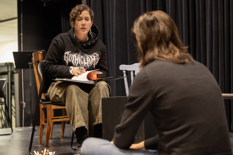 Student actor and director working together during a play rehearsal