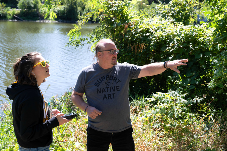 Lecturer Mark Bruckner instructing a student outdoors in a sound design class
