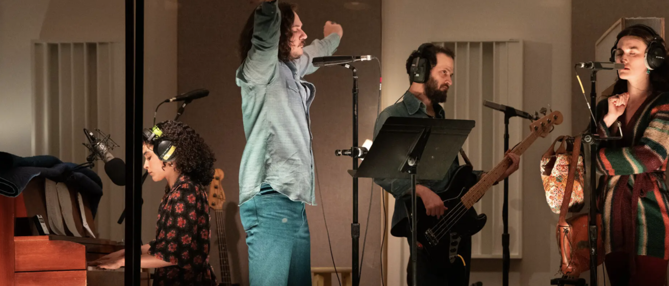The cast of Stereophonic on stage in the Broadway production set inside a recording studio