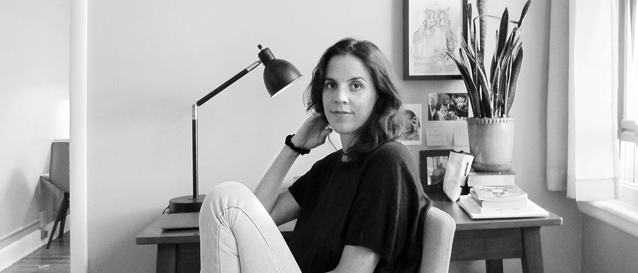 Olivia Clement seated at a writing desk