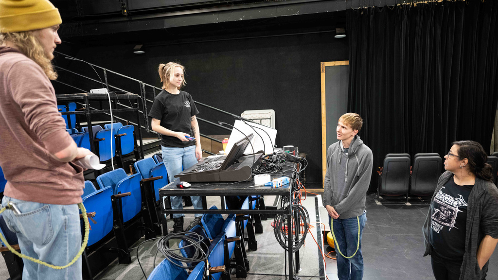 A group of 4 Theatre Arts student collaborating on lighting design in Thayer Theatre
