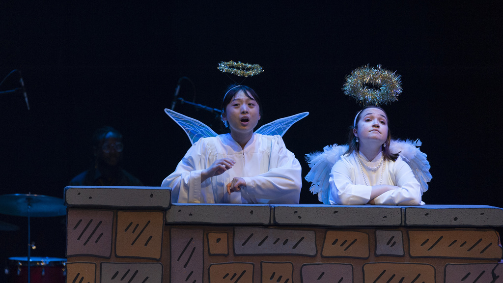 Student actors dressed as angels on stage