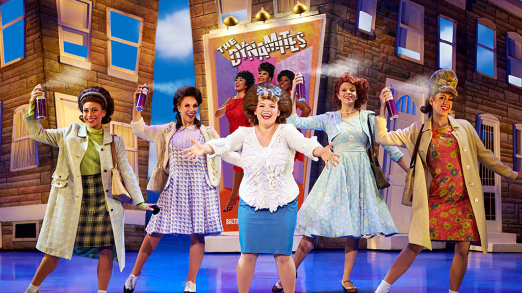 University of Iowa theatre alumna Amy Rodriguez (center) plays Tracy Turnblad in the touring Broadway production of Hairspray, which visits Hancher in February.